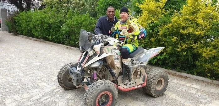 Juan Carlos Carignani on his rally quad, with Flédéric Payet beside him.